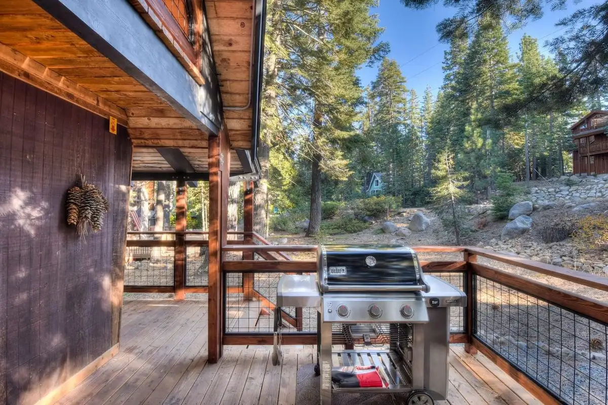 Covered deck with a grill beside the cabin wall, Enchanting Chamberlands Cabin
