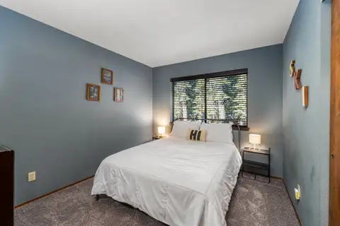 Bedroom with a bed and blue-gray walls, Grand Regency Retreat