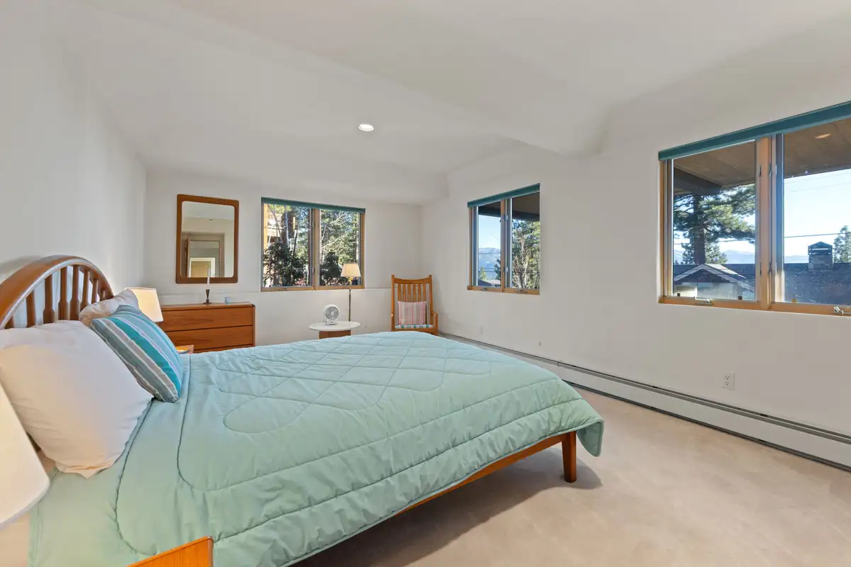 Bedroom with a bed and multiple windows, 90s Tahoe Time Capsule