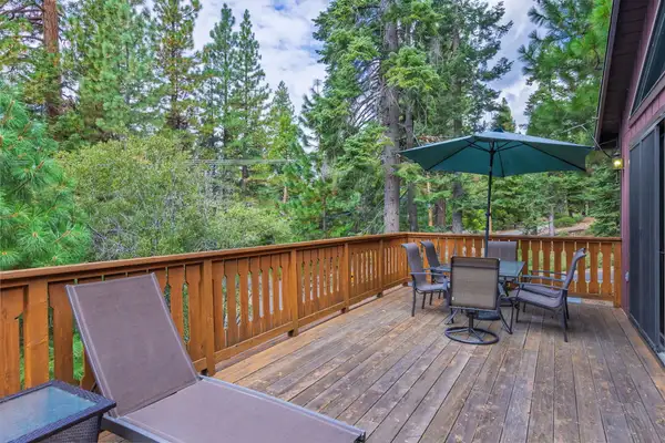 Wooden deck with lounge chair and umbrella dining set, Evergreen Hideout