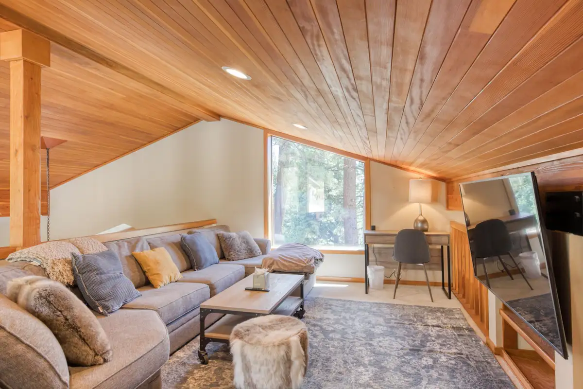 Loft lounge with sectional sofa and wood ceiling, Lunar Lakeview Haven