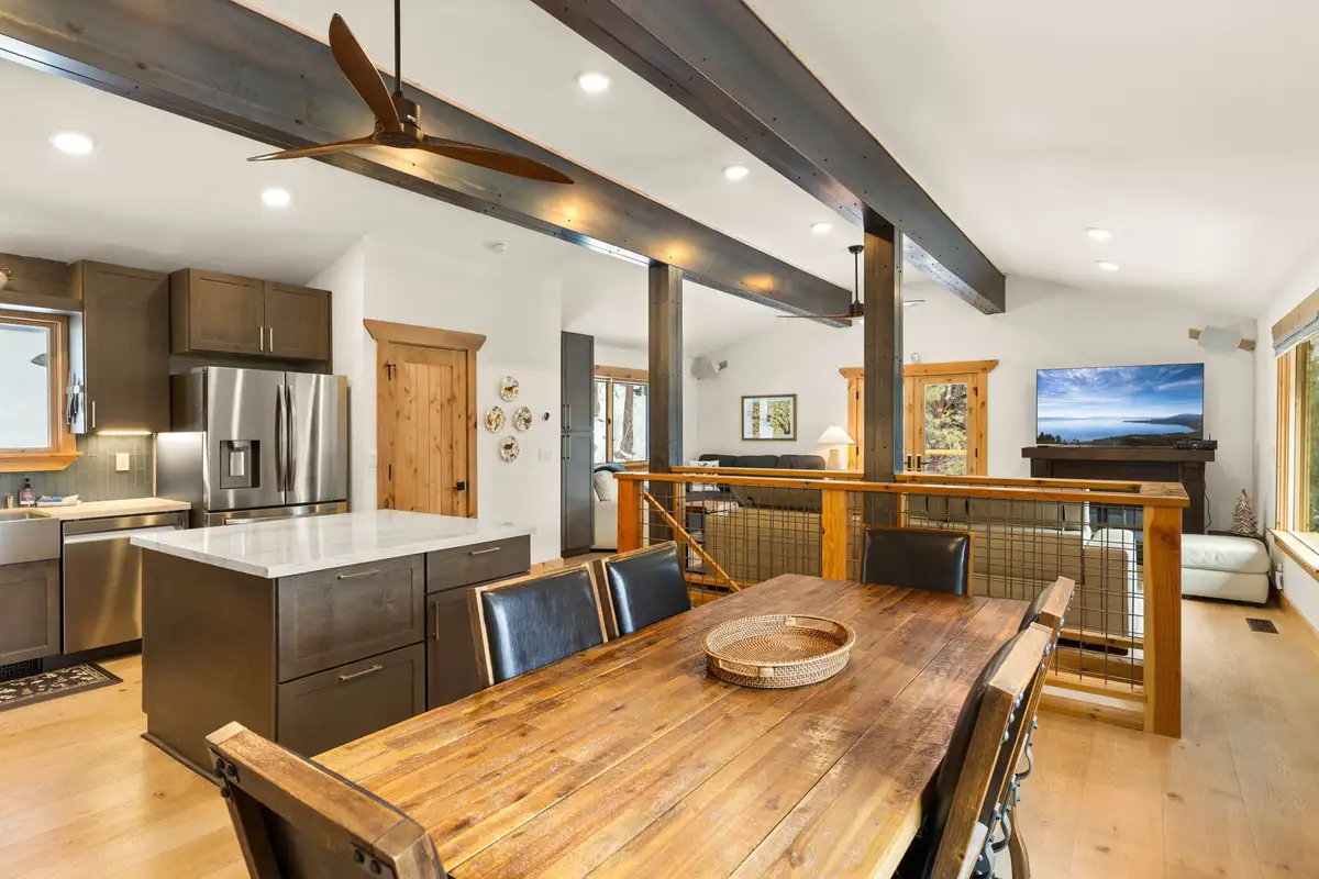 Dining table with kitchen island and living room behind, Sugar Pine Tahoe Lodge