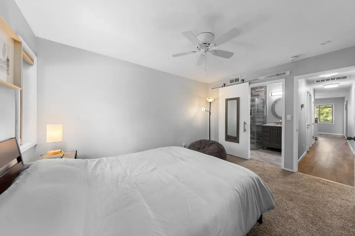 Bedroom with a bed, ceiling fan and barn door, Incline Tranquil Loft