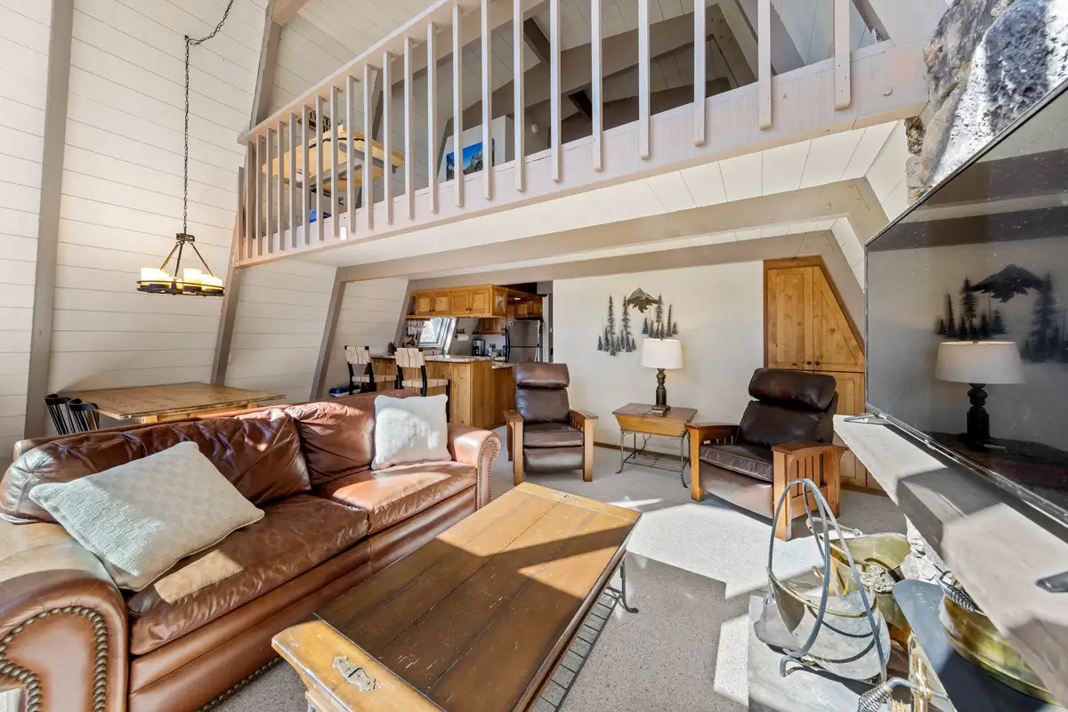 Living area with leather sofa beneath a loft, Livin' on the Edge