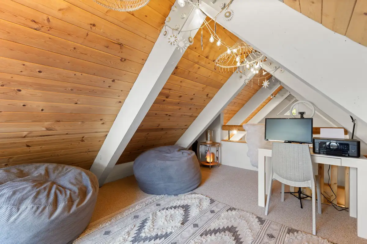 Loft with bean bags and a desk under an A-frame ceiling, Serenity Bungalow