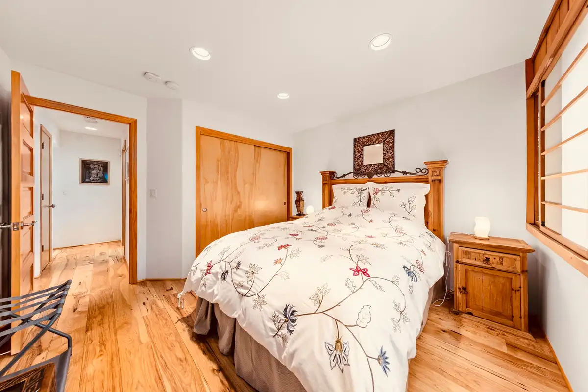 Bedroom with a wood headboard and floral bedding, Sunlit Incline Retreat