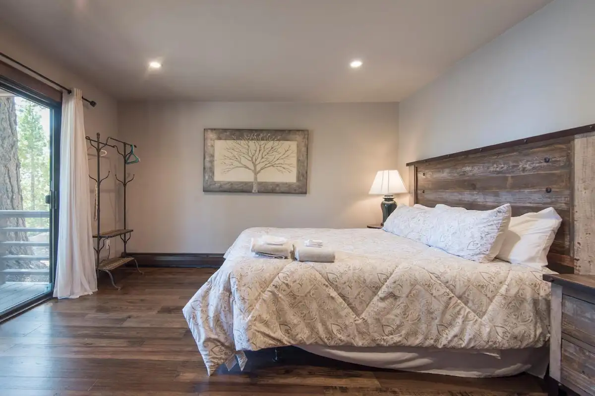 Bedroom with a reclaimed-wood headboard and sliding door, Tranquil Tahoe Haven