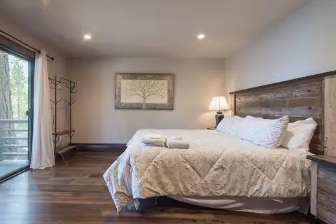 Bedroom with a reclaimed-wood headboard and sliding door, Tranquil Tahoe Haven