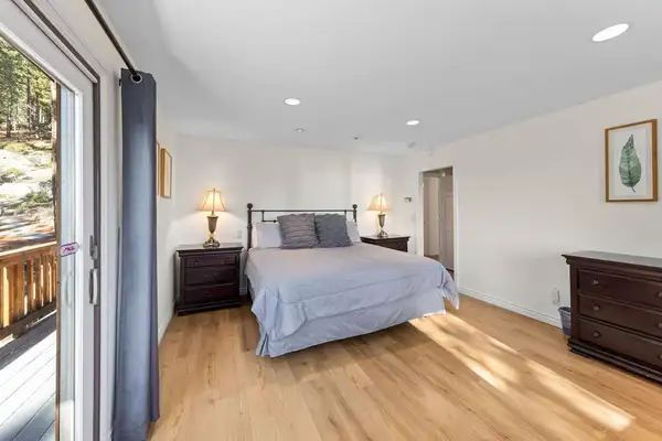 Bedroom with a bed and sliding door to a deck, Tranquil Alpine Bliss