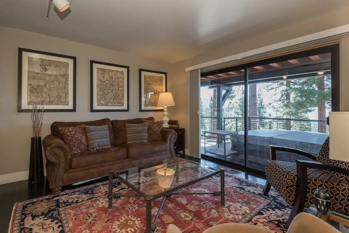 Sitting room with a leather sofa, framed maps and sliding doors, Skylake Serenity Retreat