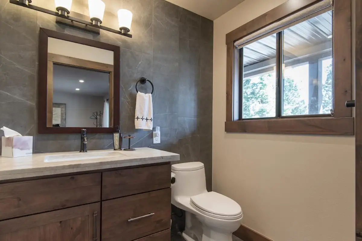Bathroom with a wood vanity and window, Tranquil Tahoe Haven
