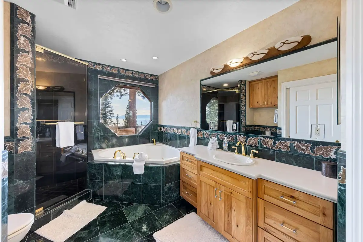 Bathroom with a corner tub, marble tile and wood vanity, Tranquil Alpine Bliss