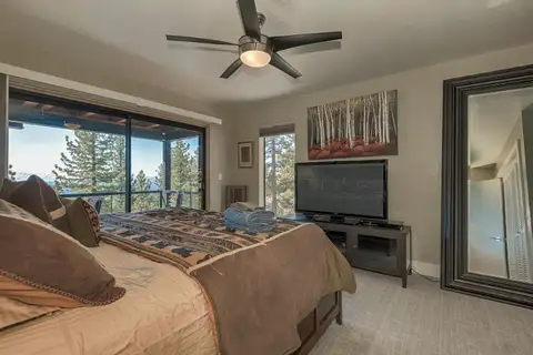 Bedroom with a ceiling fan, TV and sliding doors to a deck, Skylake Serenity Retreat