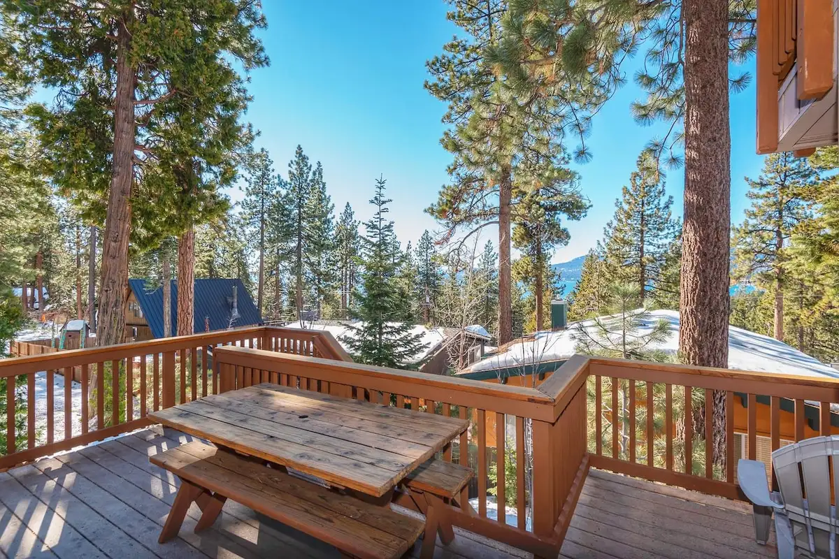 Deck with a picnic table among pines, Lakeview Serenity Cottage