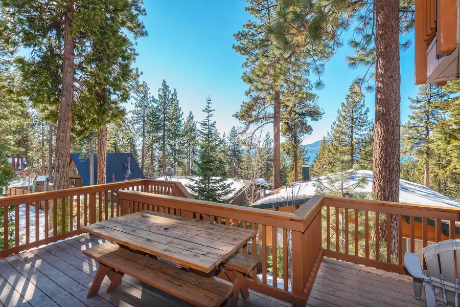 Deck with a picnic table among pines, Lakeview Serenity Cottage