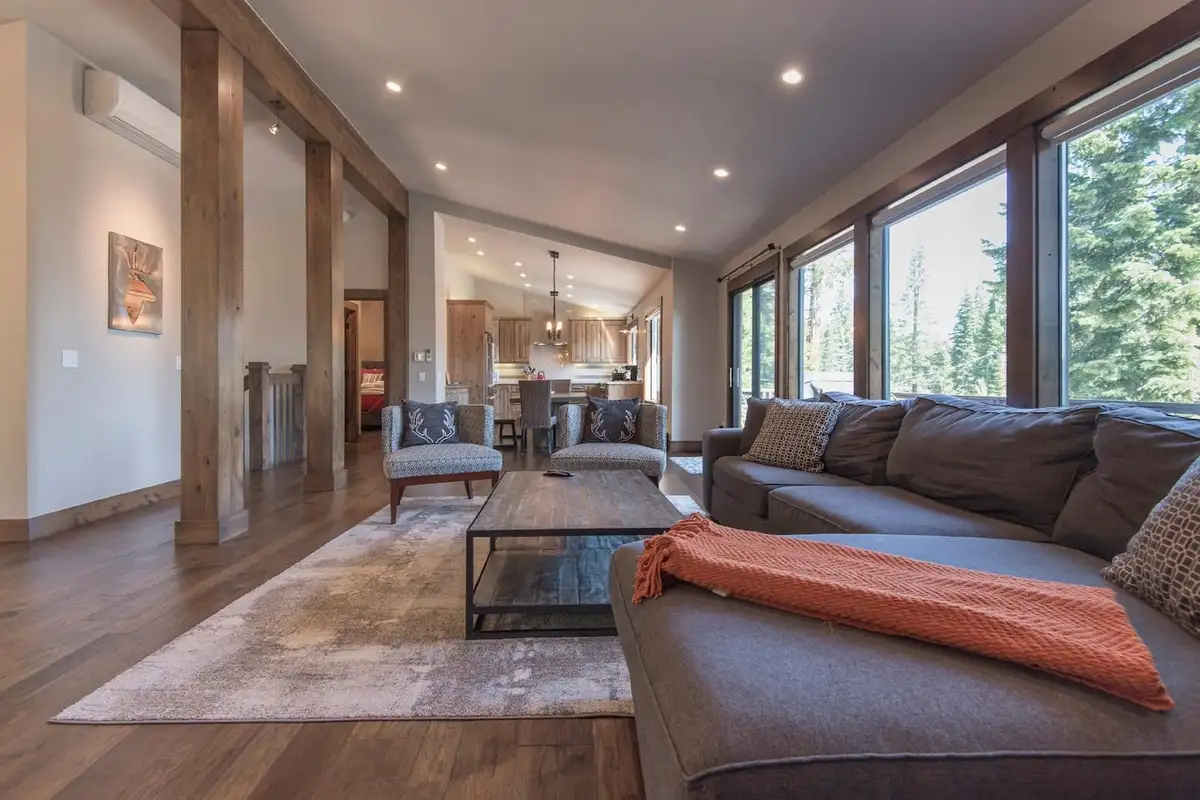 Living room with large sectional and wall of windows, Tranquil Tahoe Haven