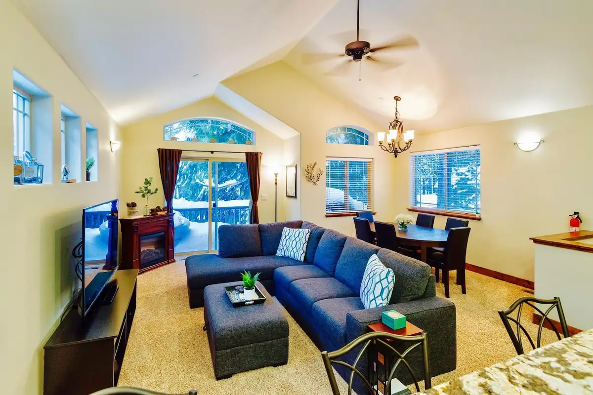 Living room with a sectional sofa and electric fireplace, Trout and About