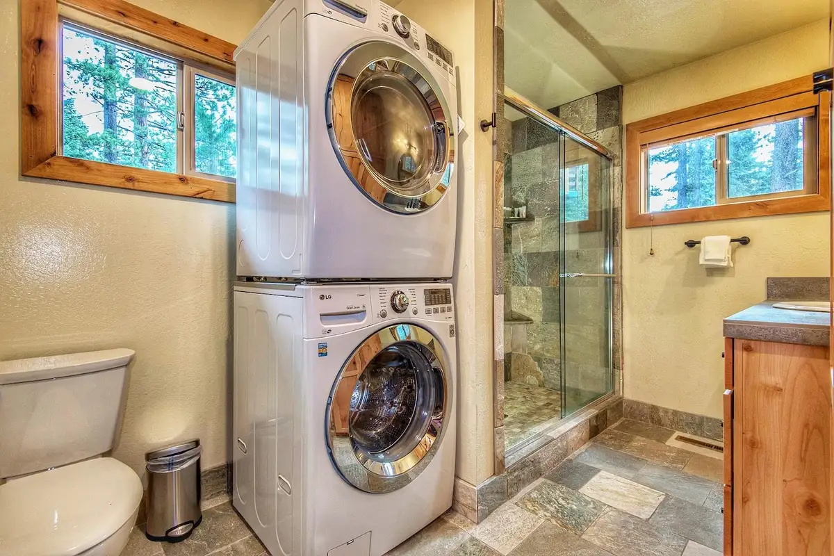 Bathroom with stacked washer and dryer and glass shower, Restful North Ridge