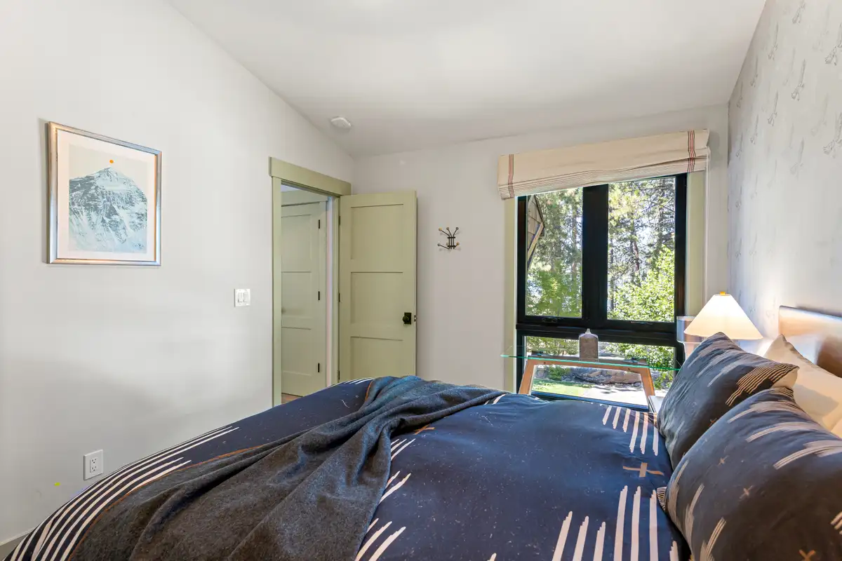 Bedroom with a bed and window to the trees, Lakeside Luxe Retreat