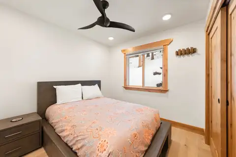Bedroom with a floral bed and ceiling fan, Sugar Pine Tahoe Lodge