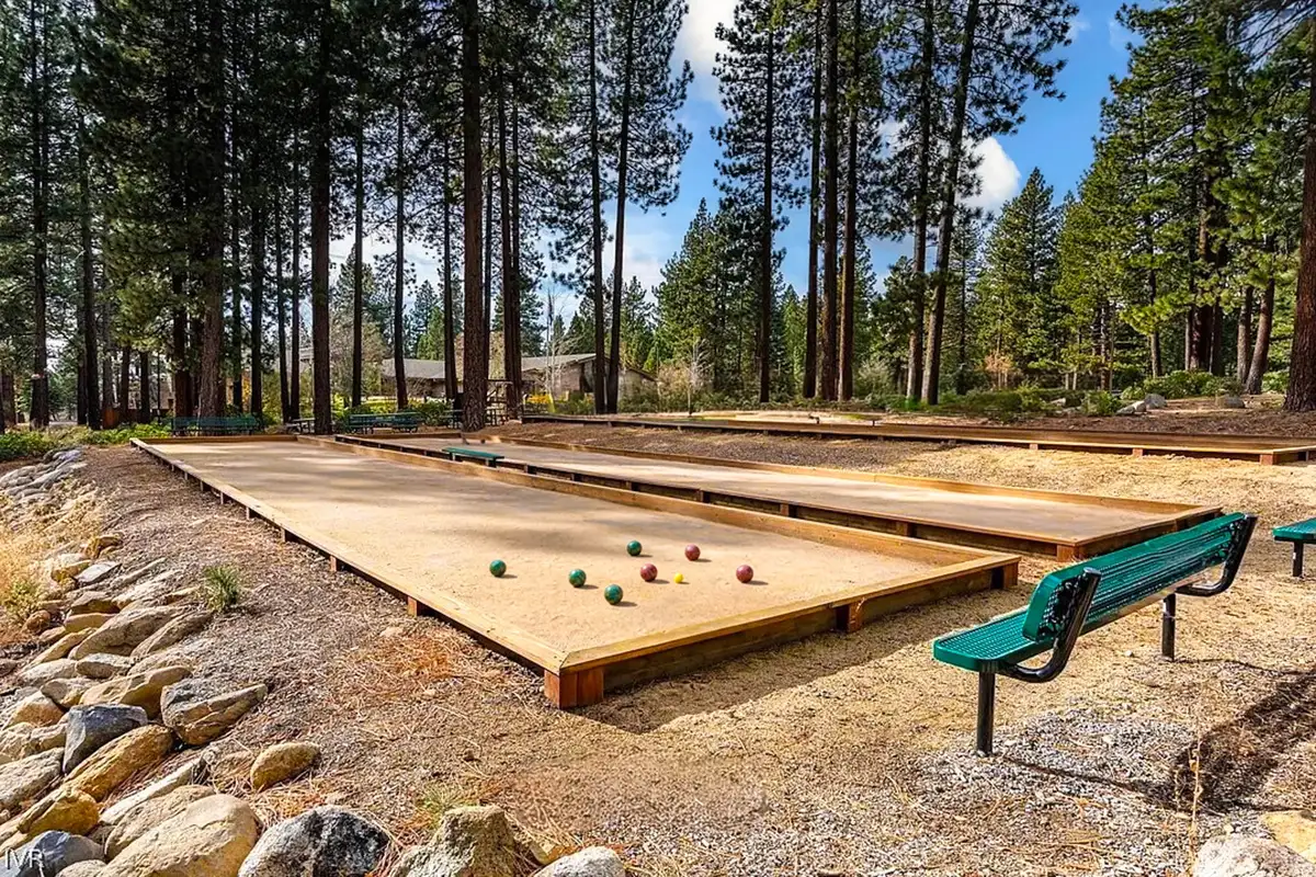 Bocce ball courts among pine trees with benches, Tahoe Peaks & Shores Retreat