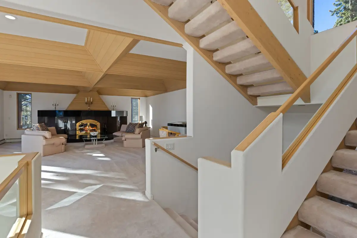 Open staircase above a living room with fireplace, 90s Tahoe Time Capsule