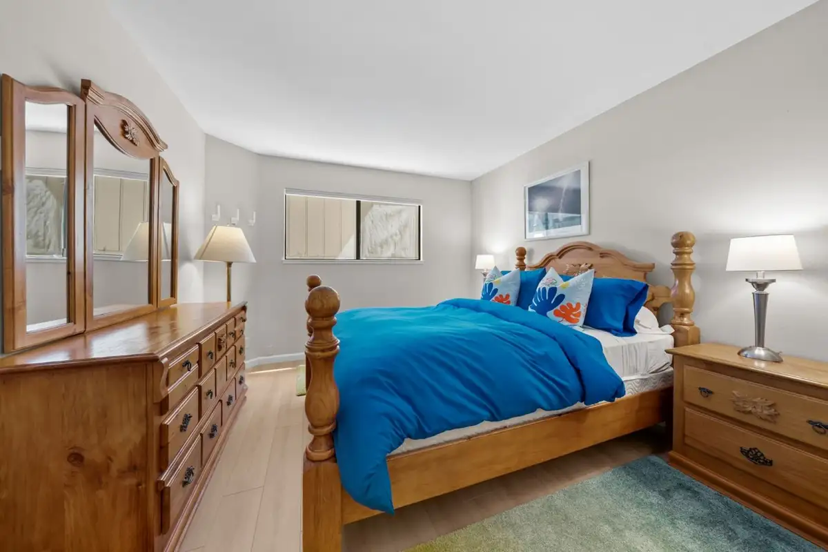 Bedroom with a four-poster bed and wood dresser, Skiway Suite