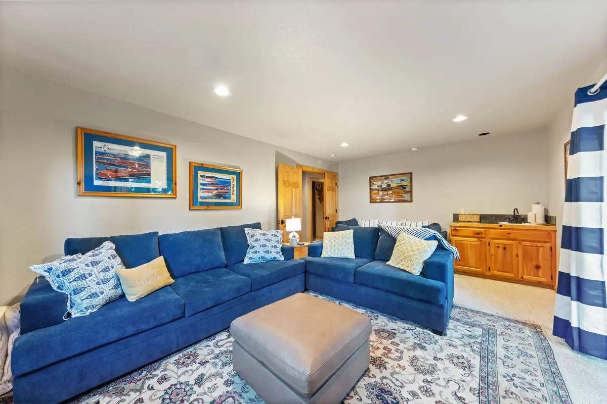 Family room with a blue sectional sofa, Lakeview Grandeur