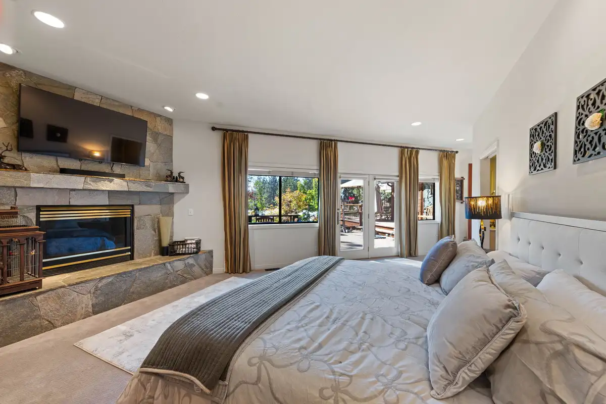 Bedroom with a bed and stone fireplace, Incline Lakeside Haven