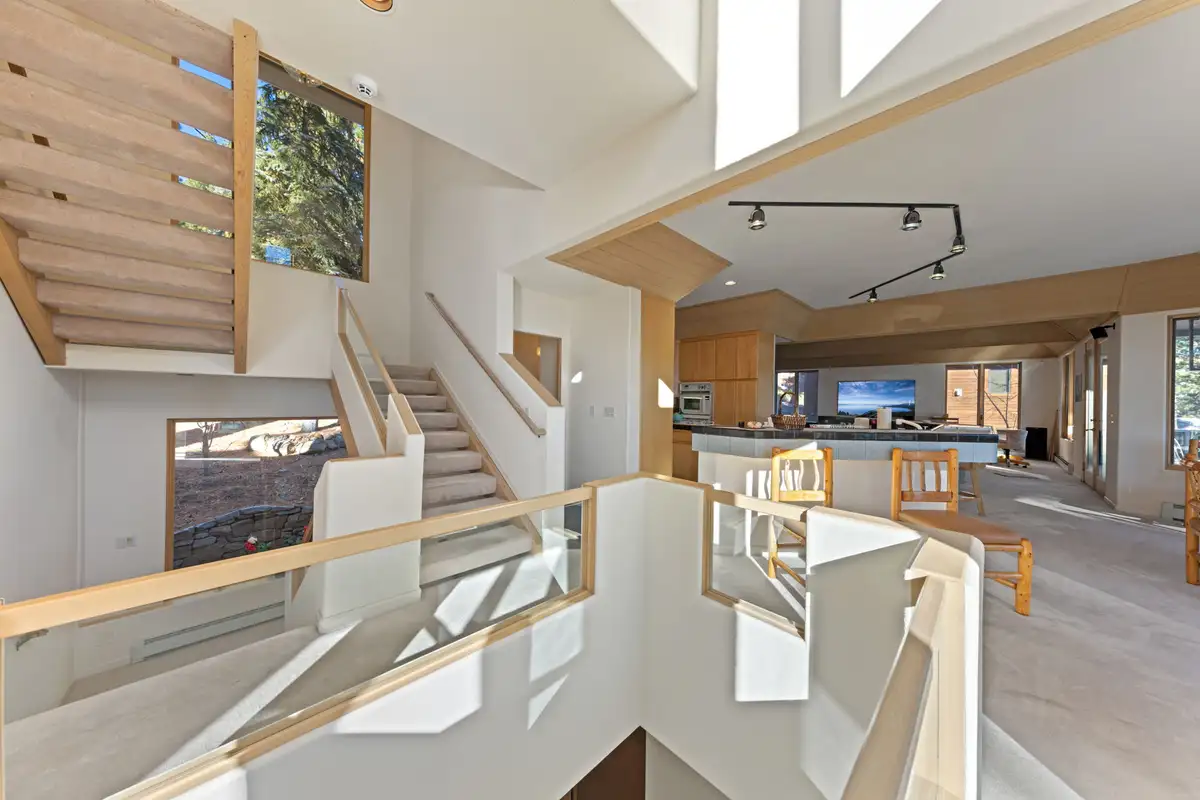 Stairway overlooking the open kitchen and living area, 90s Tahoe Time Capsule
