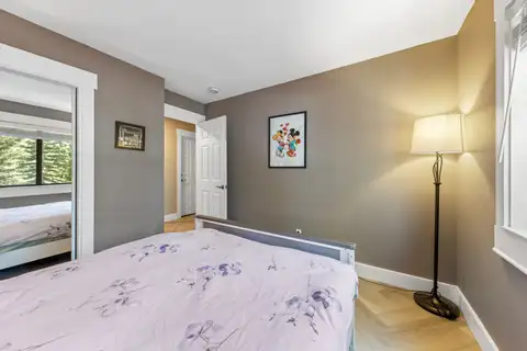 Bedroom with a bed, floor lamp and mirrored closet, Tranquil Stay