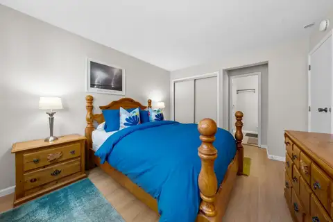 Bedroom with a four-poster bed and blue bedding, Skiway Suite