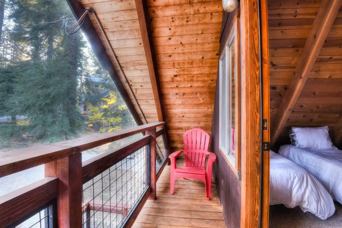 Narrow balcony with a red chair outside a bedroom, Enchanting Chamberlands Cabin