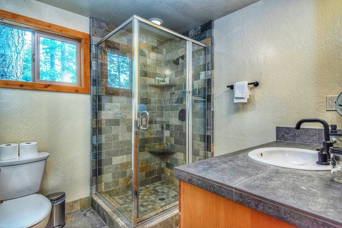 Bathroom with a slate-tiled glass shower and vanity, Restful North Ridge