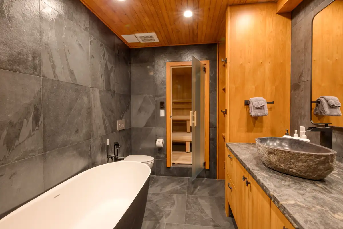Bathroom with slate walls, soaking tub and stone sink, Lunar Lakeview Haven