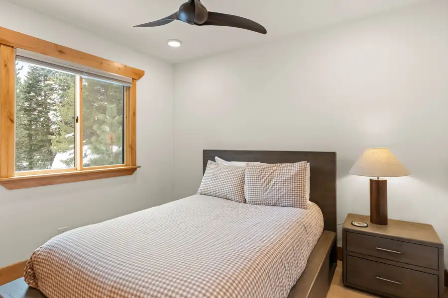 Bedroom with a gingham bed and window to pines, Sugar Pine Tahoe Lodge