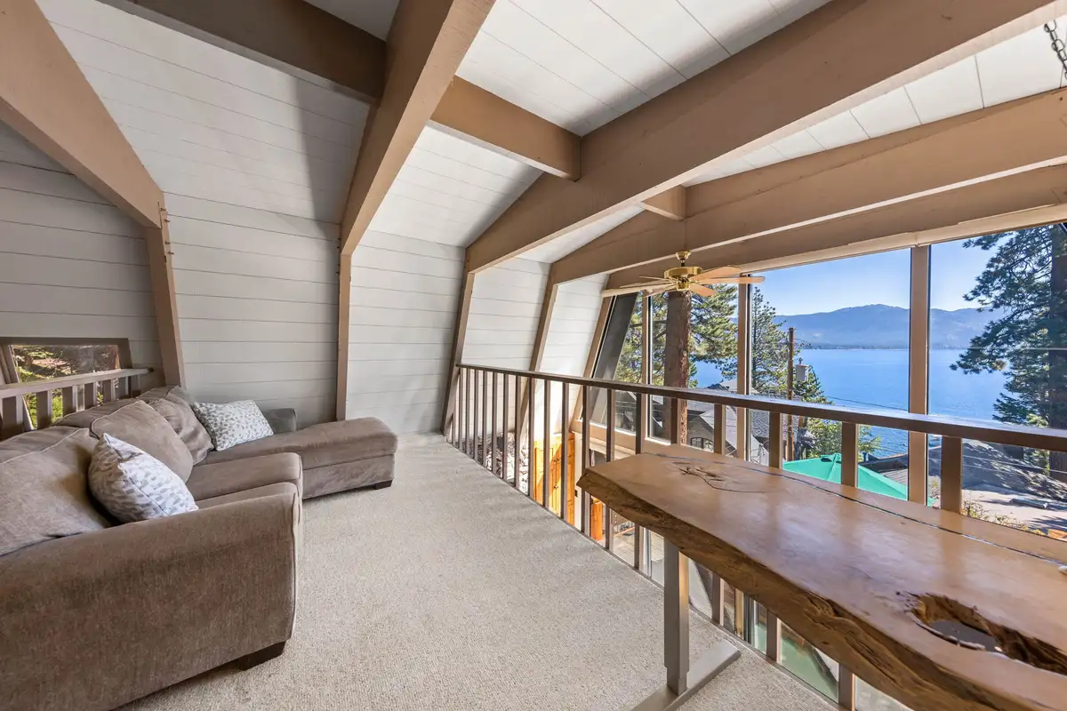 A-frame loft with sofa and Lake Tahoe through the windows, Livin' on the Edge