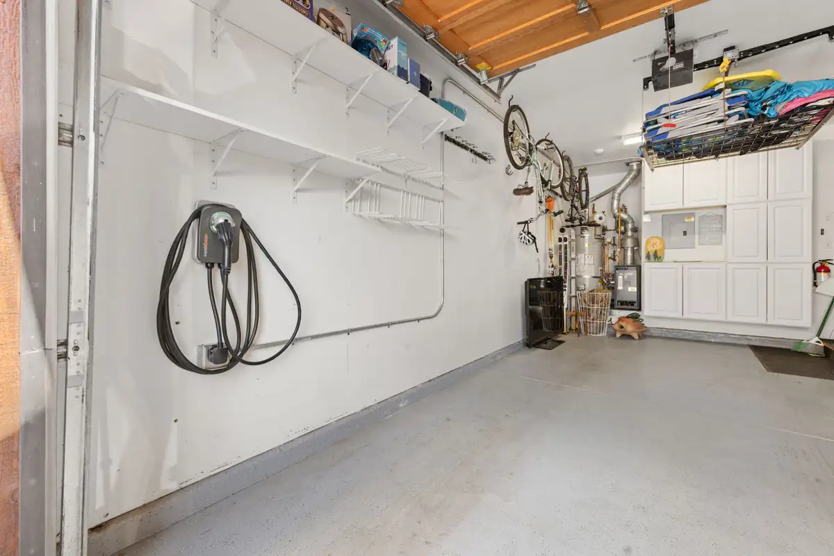 Garage with storage shelves and an EV charger, Elevated Tahoe Escape