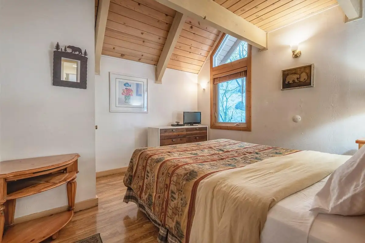 Bedroom with a sloped wood ceiling and dresser, Lakeview Serenity Cottage
