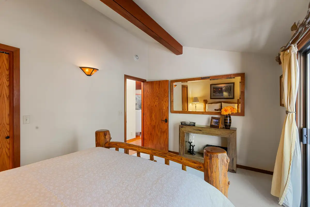 Bedroom with a log bed frame and wood beam, Incline Lakeside Haven