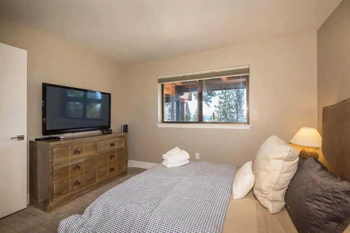 Bedroom with a bed, dresser and wall-mounted TV, Skylake Serenity Retreat