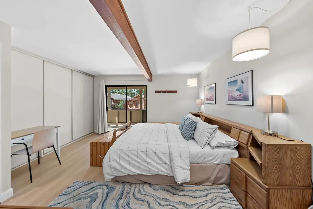 Bedroom with a bed, desk and sliding closet, Skiway Suite