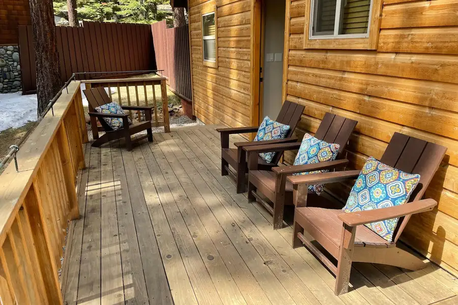 Covered porch with wooden Adirondack chairs, Restful North Ridge