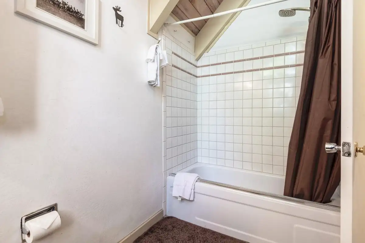 Bathroom with white tiled tub and shower, Lakeview Serenity Cottage
