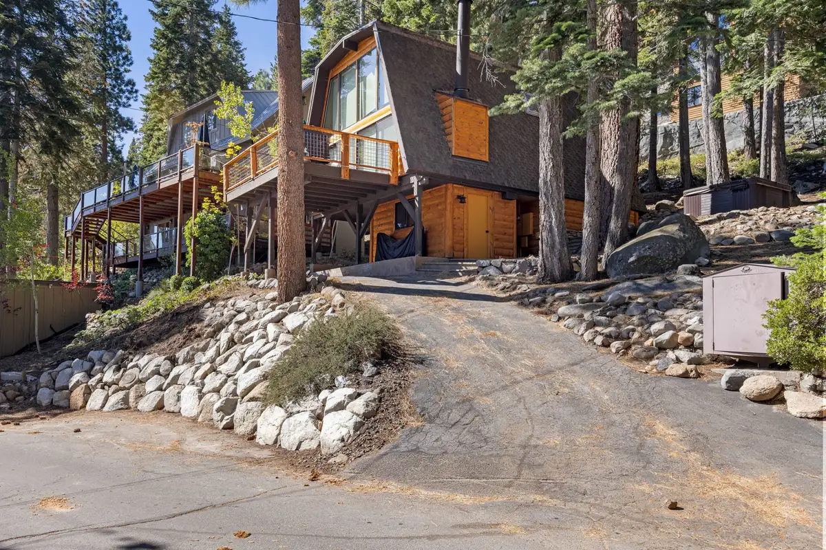 A-frame cabin above a sloped driveway among pines, Livin' on the Edge