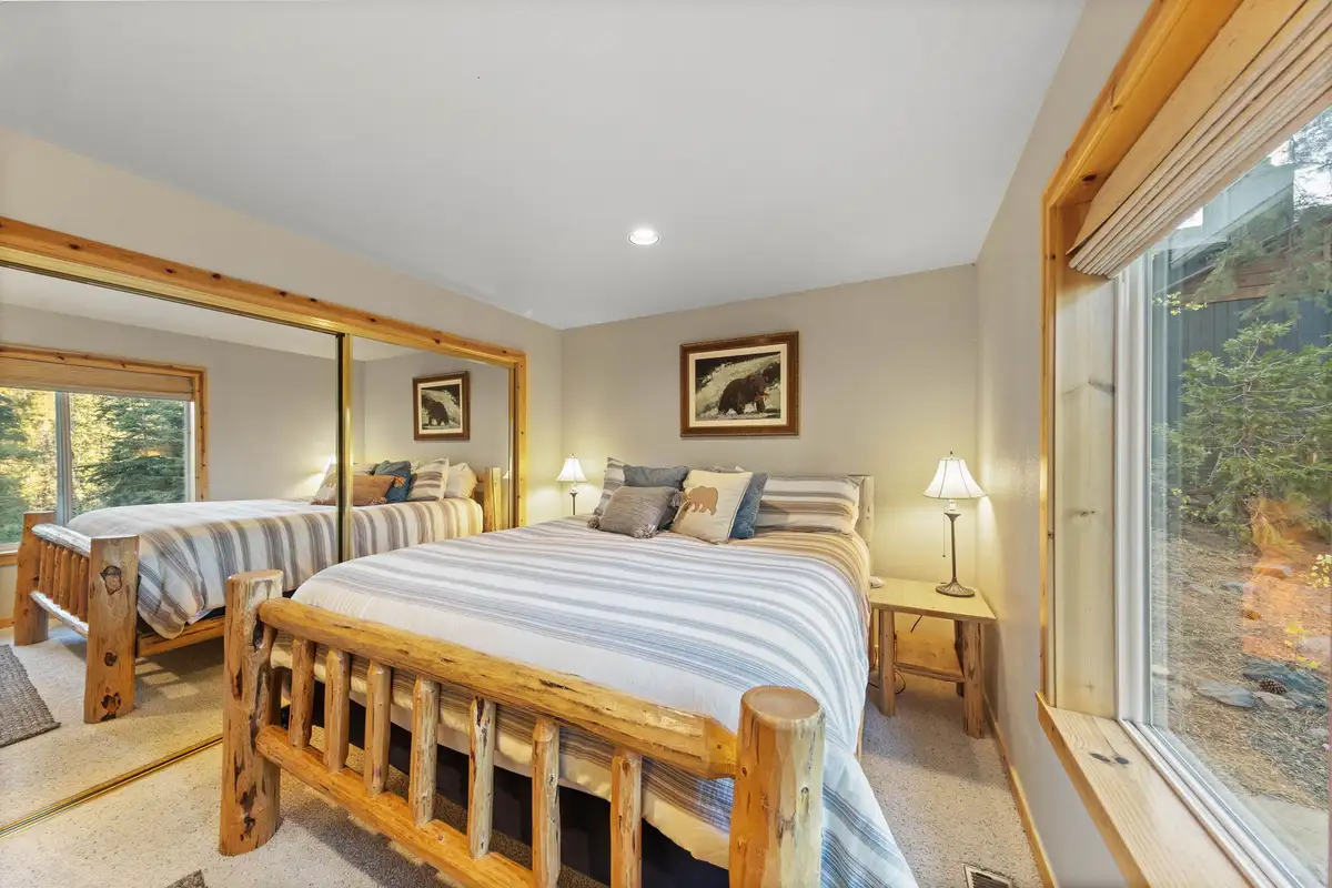 Bedroom with a log bed and large window to the trees, Lakeview Grandeur