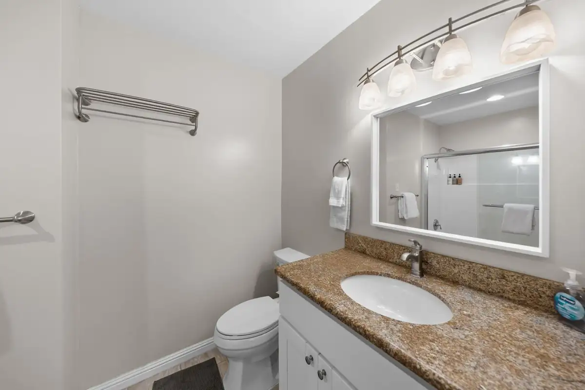 Bathroom with a granite vanity and lighted mirror, Skiway Suite