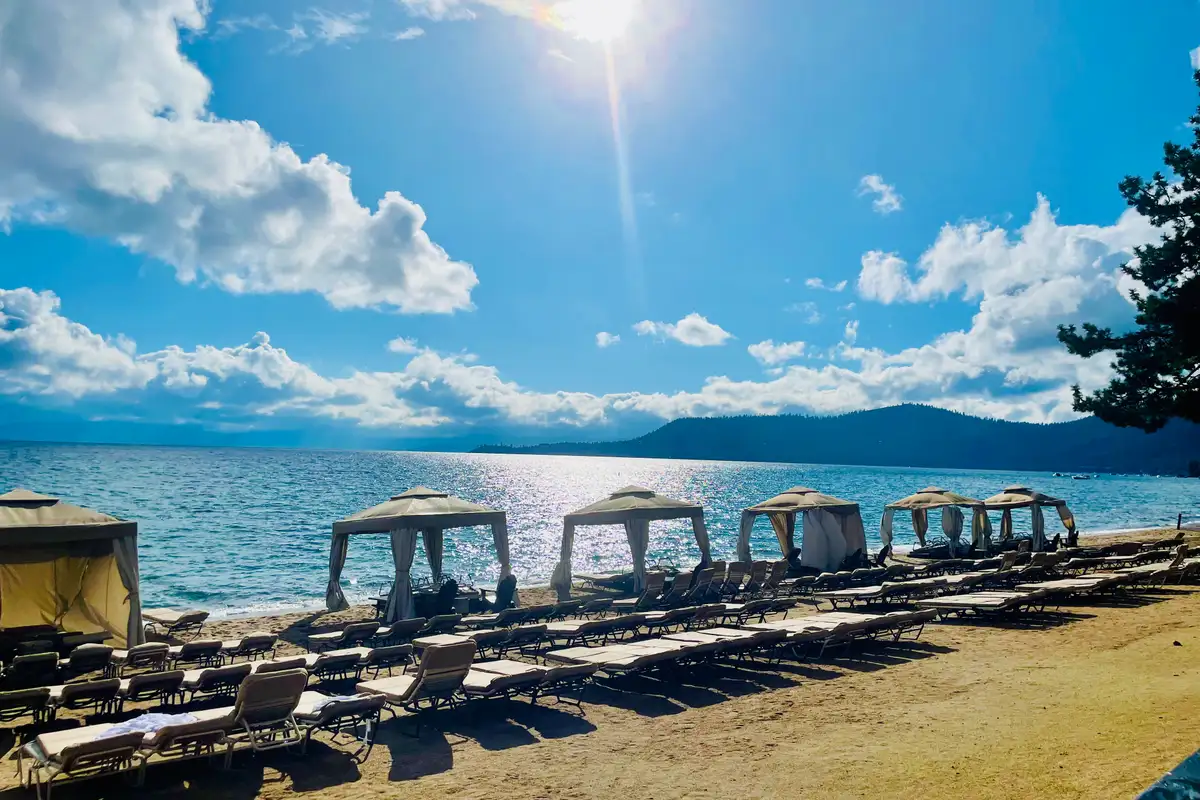 Beach cabanas and lounge chairs on a lakeshore, Sunlit Incline Retreat