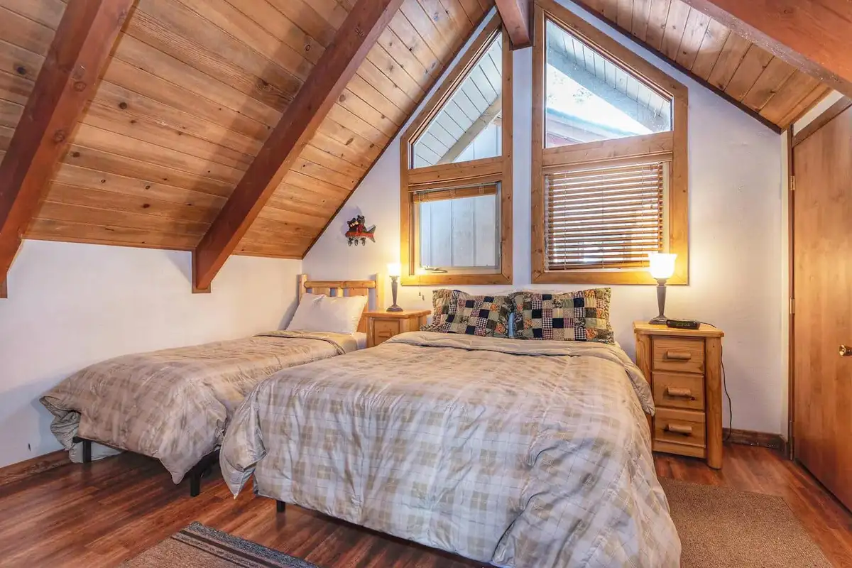 A-frame bedroom with two beds under a wood ceiling, Lakeview Serenity Cottage
