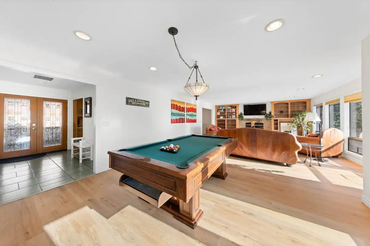 Game room with a pool table and seating area beyond, Tranquil Alpine Bliss